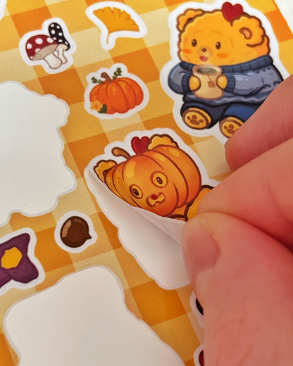 Peeling a pumpkin Fried Bear sticker off the Fall sticker sheet