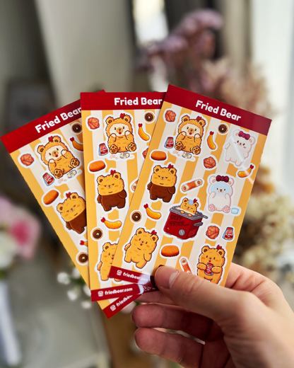 Three Fried Bear sticker sheets with Fried Bear, Tofu Bear and fried foods fanned out in a hand