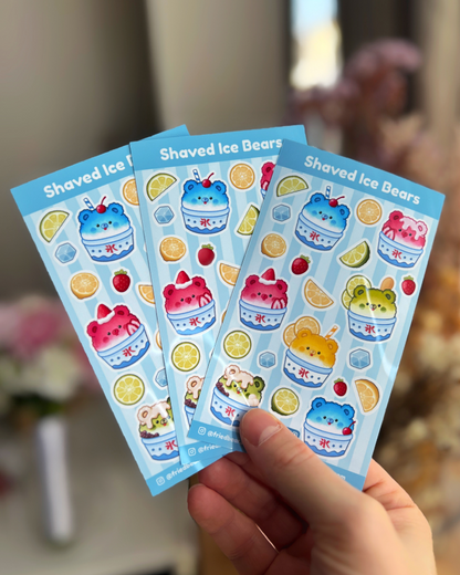 Three Shaved Ice Bears sticker sheets with bears in kakigori cups and fruit fanned out in a hand